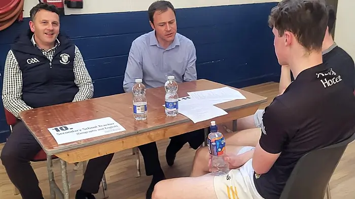 Some students chatting with, and getting advice from two Bandon GAA Club members Niall O'Rourke (secondary school teacher at Clonakilty Community College) and Rob Daly (mechanical engineer) at the recent careers night initiative organised by the Bandon GAA Club.
