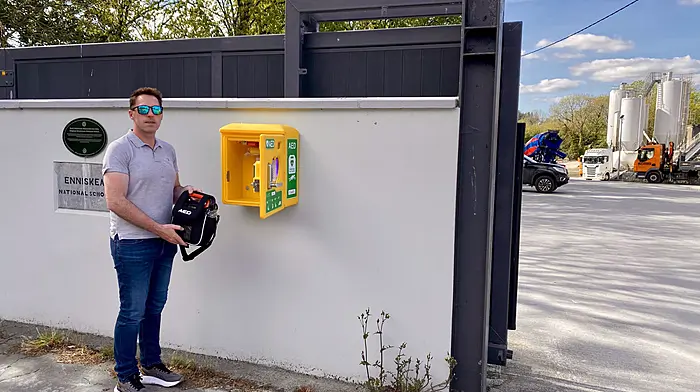 Michael Keohane of Keohanes Readymix Ltd placing the defibrillator into the AED unit at their premises in Enniskeane.
