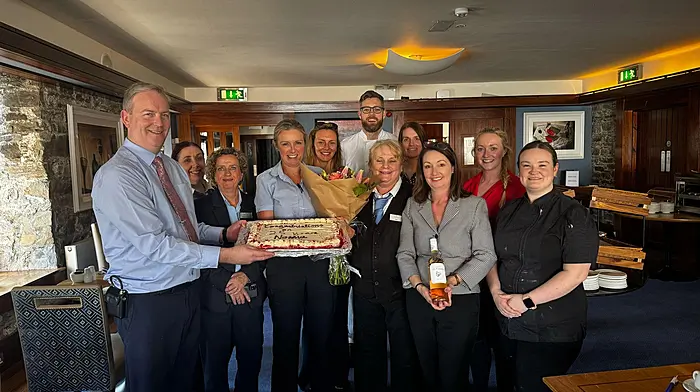 Norma Collins with her colleagues from the Trident Hotel at a celebration where Norma was rewarded for 25 years of unbroken service at the hotel.