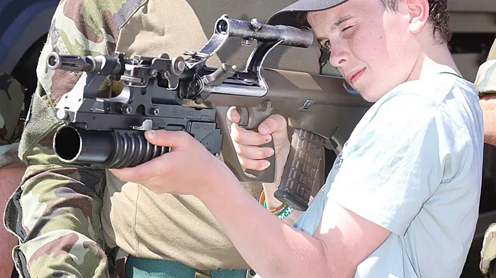 Young Tom O'Connor checking out the hardware at the Reserve Defence Force Display at Bandon Show, under the watchful eye of Corporal Kevin Buttimer, F Coy 12BN, Skibbereen. (Photo: Donie Hurley)