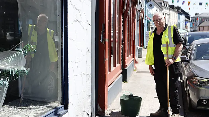 John Walsh, a member of Schull Tidy Towns, has been busy cleaning the Main Street pavement in preparation for this week’s Fastnet Film Festival.  (Photo: Carlos Benlayo)