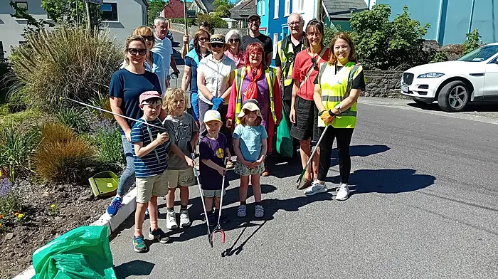 Maura Allen on Pier Road surrounded by her band of civic-minded helpers last Saturday as they cleaned up the village in preparation for the Fastnet Film Festival visitors.