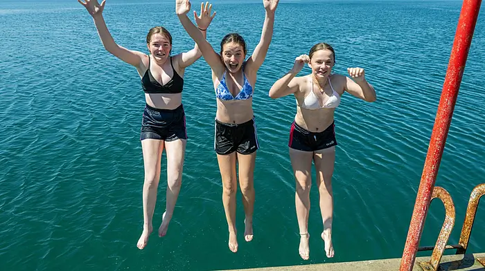 Sophie O'Donnell, Kasey Cotter and Callie O'Donoghue, all from Bantry, having fun in the sun and cooling off by jumping into the sea. (Photo: Andy Gibson)