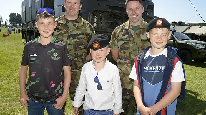 Darragh, Micheál and Cathal Gleeson from Skibbereen with Reserve Defence Force members Trevar Sheehan and Humphrey Lynch at the agricultural show in Bandon.   (Photo: Denis Boyle)