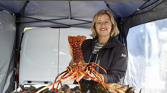 Evie Bokuma selling fresh lobster and crabs at Sunday market in Schull. (Photo: Carlos Benlayo)