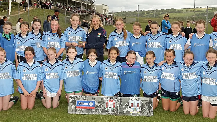 Roinn 2 Girls winners St Mary's Senior School Dunmanway receive the trophy from Cork footballer Laura O'Mahony. (Photo: Paddy Feen)