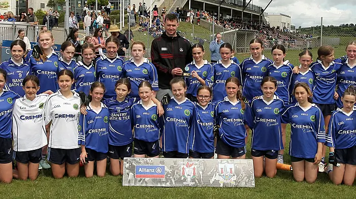 Roinn 1 Girls runners-up Scoil Mhuire agus Bhaire with Cork footballer Maurice Shanley.