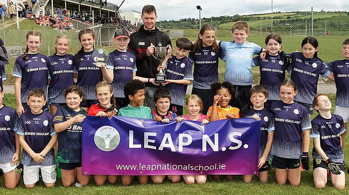 Roinn 9 Mixed winners Leap NS receive the trophy from Cork footballer Maurice Shanley. (Photo: Paddy Feen)