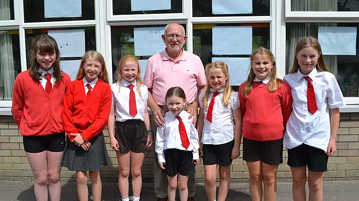 Tadhg Murphy from Rosscarbery with seven of his granddaughters who are currently pupils at St Mary's National School in Rosscarbery, Amy Murphy, Clodagh Duggan, Eabha Duggan, Siún Duggan, Orla Murphy, Aisling Murphy and Meabh Murphy. (Photo: Anne Minihane)