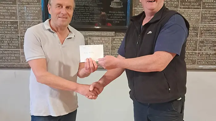 Barry Herlihy, winner of the Doheny lotto jackpot, being presented with a cheque of €3,800 from Doheny GAA chairman, Mark Farr.