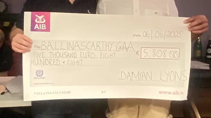 Damien Lyons presenting his winners cheque of €5,808 to Ballinascarthy GAA chairperson, Michael Ryan.