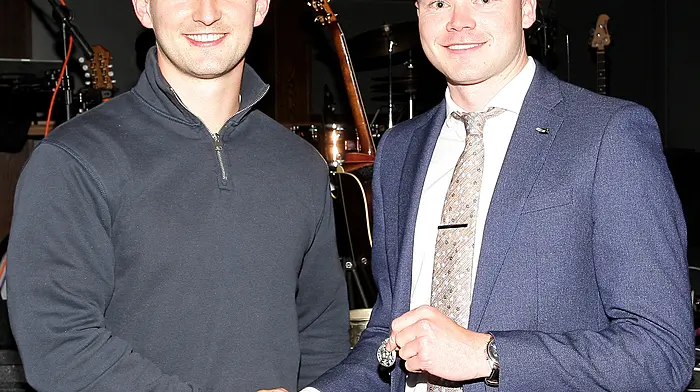 Special guest and Cork senior hurler Shane Kingston presents the team captain Padraig Reidy with his county medal.