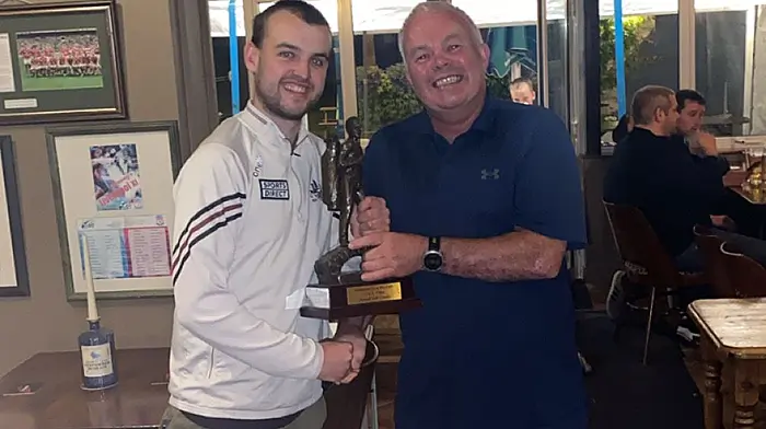 Colin Farr presenting the club classic GUI winning team captain Declan O'Shea with Doheny/Sam Maguire annual golf classic trophy.