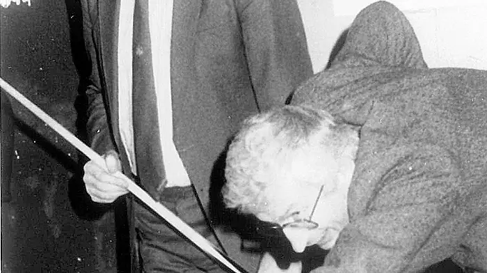 49.	Jim O’Keeffe T.D. ‘snookered’ by Joe Walsh Minister for Food at the opening of Paddy Boyles Bandon team snooker competition. (November 1988)