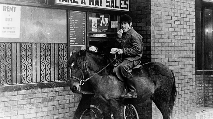 No nosebag for the pony on this occasion, but its rider enjoyed a tasty bag of chips courtesy of The Busy Bee on Ilen Street, Skibbereen in 1980. (Photo: Michael Minihane)