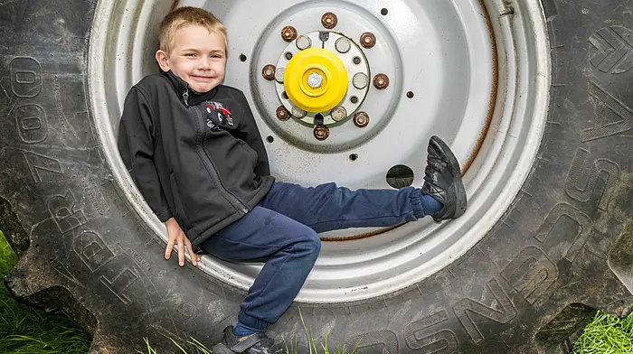 Lyre, West Cork, Ireland. 22nd Jun, 2025. A charity Tractor, Truck, Car and Motorcycle Run was held in Lyre, West Cork today. The run was in aid of Knockskeagh National School; Cancer Connect - West Cork and West Cork Rapid Response. Relaxing on his dad's tractor wheel was 6 year old Tommy Collins from Lyre. Picture: Andy Gibson.