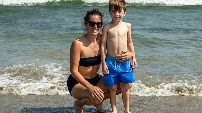 Rosscarbery, West Cork, Ireland. 19th Jun, 2025. Sunshine and 26C temperatures brought people to the Warren Beach in Rosscarbery today. Cooling off in the sea were Elaine and Noah Shanahan from Rosscarbery. Picture: Andy Gibson.