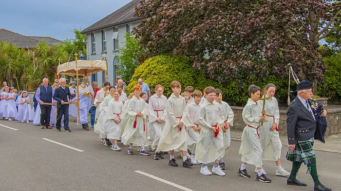 Piper Michael Heaney leading the Corpus Christi procession through Timoleague followed by altar servers, Fr John Kingston and parishioners.  (Photo: Gearoid Holland)