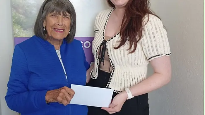 Carol Gilbert of Made In West Cork (distribution) Ltd presenting a cheque for €300 to Sinead Keohane of Cancer Connect, the proceeds of the sale of cards designed by Hammond Journeaux.