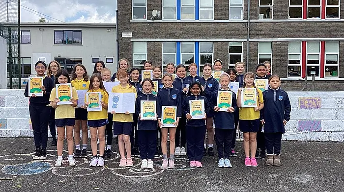The fourth class students at Bandon Primary School proudly displaying copies of their first self-published book, Wild Wonders of the World.