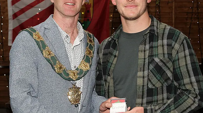 Mayor of Clonakilty Conan O'Donovan presents medals to the Clonakilty Soccer Club captain Reuben Henry.