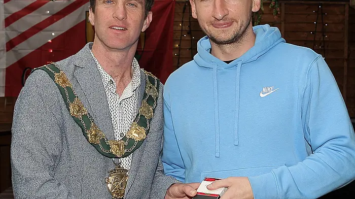Eoin Hartnett receives his medals from the Mayor of Clonakilty Conan O'Donovan.