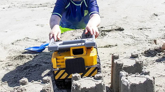 Mathew McCaughy using earth moving equipment to help him build his sandcastles on the beach at Keelbeg during the hot weather.  (Photo: Andrew Harris)