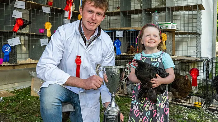 Three-year-old Katie Stafford from Rosscarbery with judge Darren Keohane at the annual Dunmanway Agricultural Show last Sunday where Katie won first place with her Pecan Hen in the poultry junior category.   (Photo: Andy Gibson)