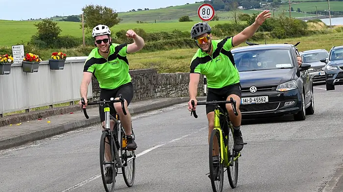 Ross and Niall O'Hanlon cycling over Church Bridge and entering Timoleague last Friday where they completed their memorial cycle.