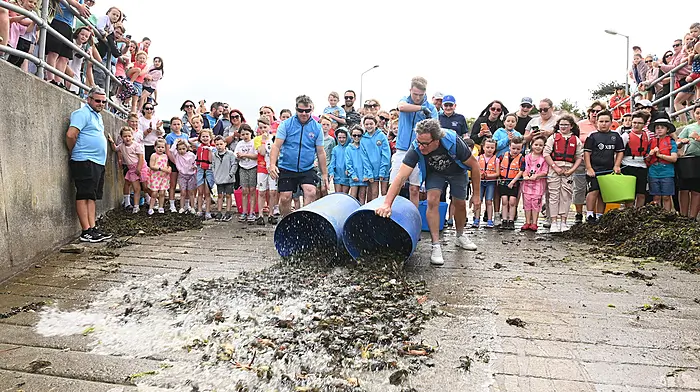 Making a splash as the crabs return to the sea at the end of children's crab fishing competition during the Courtmacsherry Harbour Festival.  (Photo: Martin Walsh)