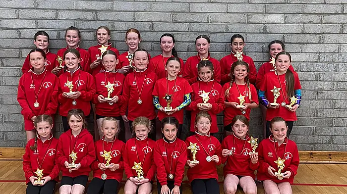 The Clonakilty Gymnastics Club tumbling team with their trophies.