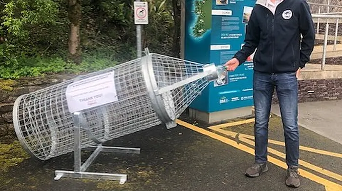 Darragh O'Shea admires one of the new recylcing bins provided Glengarrif Tidy Towns by the council.