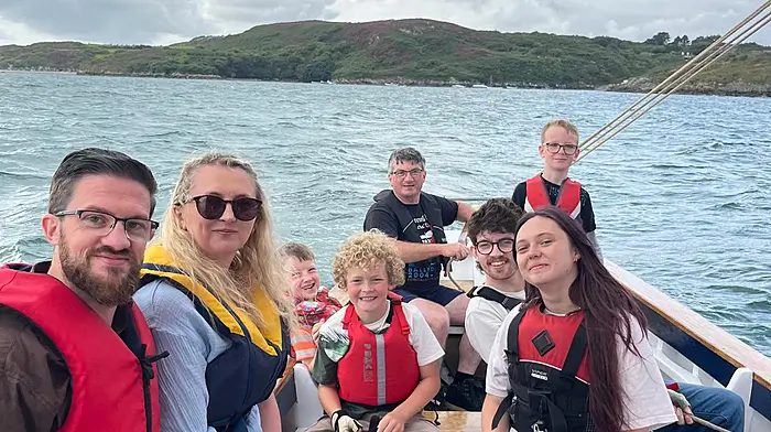 Cormac Levis steering his boat 'Saoirse Muireann' with passengers Simon Levis, Amy Harrison, Joseph Harrison O’Connor, Cormac Vickerton Levis, Ziggy Vickerton Cooley, Hugh Levis, and Grainne Browne at the boat gathering in Ballydehob.