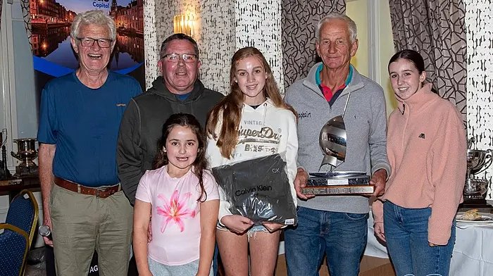Schull Harbour Sailing Club Commodore Jack Allen (far left) was more than delighted to present Schull skipper of Witchcraft, Simon Nelson, the trophy for an overall win of Class 4 at the end of Calves Week.  It was a great achievement for Simon and his crew, Pat Coughlan and daughters Freya (left) and Annie.  The youngest Coughlan, Tierna, was chief cheerleader for the day.