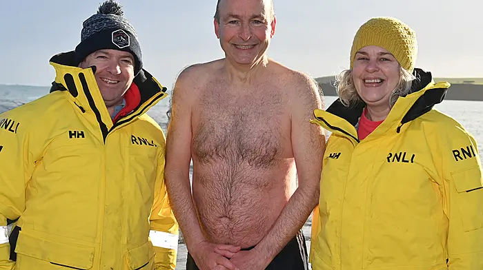 Tánaiste Micheál Martin with Courtmacshery RNLI crew members Dan Daly and Niamh Hurley at the Courtmacsherry RNLI New Year's Day Swim at Broadstrand.  (Photo: Martin Walsh)