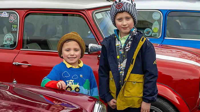 CJ and Fiachra Lynch, Bandon, took an interest in vintage minis at the Bandon tractor run on Sunday, which was in aid of Bandon Special Olympics, Bandon Athletics Club and Bandon Union of Parishes. (Photo: Andy Gibson)