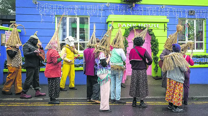 The Wren musicians, disguised in their straw hats and rags, played music as they walked the streets between visiting each of the bars in Ballydehob on St Stephen’s Day.  (Photo: Celia Bartlett)