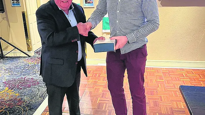 Doheny GAA club president Denis Collins presenting the club Person of the Year award to Donal O’Sullivan at the Doheny GAA social.