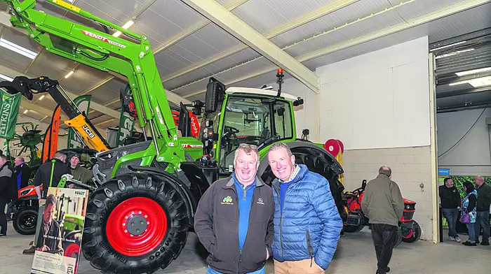 Jim O'Mahony (Kilbrittain) and Tim Troy (Midleton) enjoying day one of the first of The Spring Farm Machinery Shows which took place in the Green Glens Arena, Millstreet. In the background was the all new Fendt 620 tractor with a JCB TM320 also on the Atkins stand. Atkins was recently announced as the new JCB agri dealer covering the Cork area.  (Photo: David Patterson)