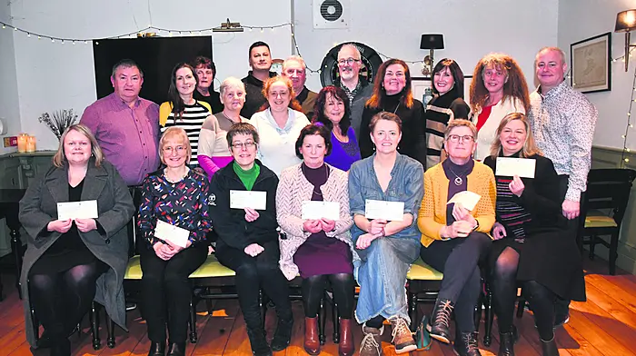 Members of the Leap Scarecrow Festival committee (in the back row) who presented cheques to local schools and charities at the Harbour Bar. Those who collected cheques on the night were (front, from left): Deirdre Pyburn (Maultrahane NS), Breda Connolly (Skibbereen Geriatric Society), Rhona Deane (West Cork Rapid Response), Mary Crowley (Leap NS), Ríona Murray (Glandore NS), Sue Brockman (Rosscarbery Meals on Wheels), and Juliette O'Donoghue (CoAction).  (Photo: Anne Minihane)