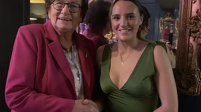 Betty Hennessy presenting camogie captain Annie Condon with her premier junior county medal.