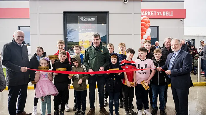 At the official ribbon cutting ceremony of the new Lisavaird Costcutter store, Jer Deasy, World Ploughing Champion (centre) was joined by local school children, Jim Barry (left), James Healy (chairmain of Lisaviard Co-op committee of management) and Martin Dineen (right), ceo of Lisavaird Co-op.