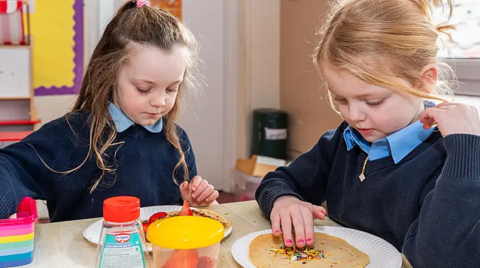 Sofia Lyall and Sophie Brennan decorating their pancakes on Shrove Tuesday. (Photo: Andy Gibson)