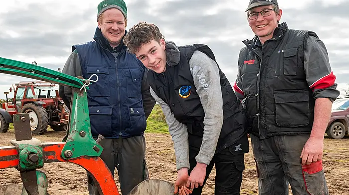 Young Jerry O'Riordan from Kilmichael, flanked by family members Kevin (left) and Daniel at the ploughing in Aghabullogue recently. Adam, Joshua and Ava Murnane from Macroom also attended, but they're a bit away from taking part just yet!  Meanwhile, Liam O'Driscoll of Kilbrittain kept a close eye on things in his Massey Ferguson 5711. (Photos: Andy Gibson & David Patterson)