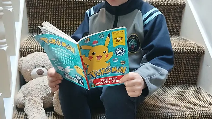 Harry O'Sullivan (Bantry) with BB the school bear from Kealkill National School, who is enjoying hearing a story from Harry’s World Book Day choice, the Pokémon epic pocket guide.
