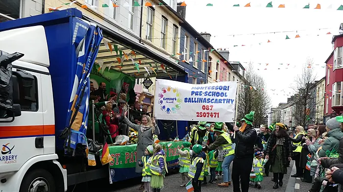 Jenny's pre-school in Ballinascarthy waving as they pass the reviewing stand at the Clonakilty St Patrick's Day parade.