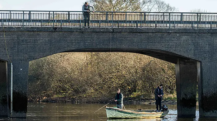 On a warm and sunny day in West Cork, three young fishermen fish for pike in Carrigadrohid Lake near Macroom.  (Photo: Andy Gibson)
