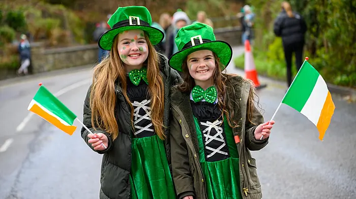 Clockwise from above: Lucy and Jessica Hunt from Belgooly enjoying the festival parade in Kinsale. Michael and Derval Murphy with their dog Pippa on St Patrick's Day in Schull. Tom Óg Dickinson appreciates the music at the Castletownbere parade. (Photos: John Allen, Carlos Benlayo & Anne Marie Cronin)