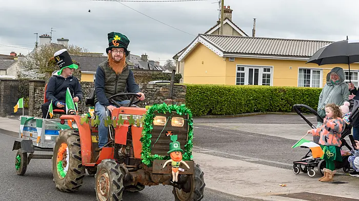 Nathan and Kelvin Kingston (Milleennagun, Dunmanway) taking part with a Massey Ferguson 1010 compact tractor and trailer at the Dunmanway St Patrick’s Day parade.  (Photo: David Patterson)