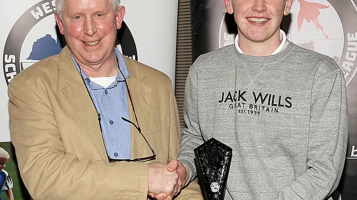 WCSL Chairman Declan Deasy presents the Overall West Cork Academy Player of the Year 2023-2024 to Seam Platt (Ardfield FC).